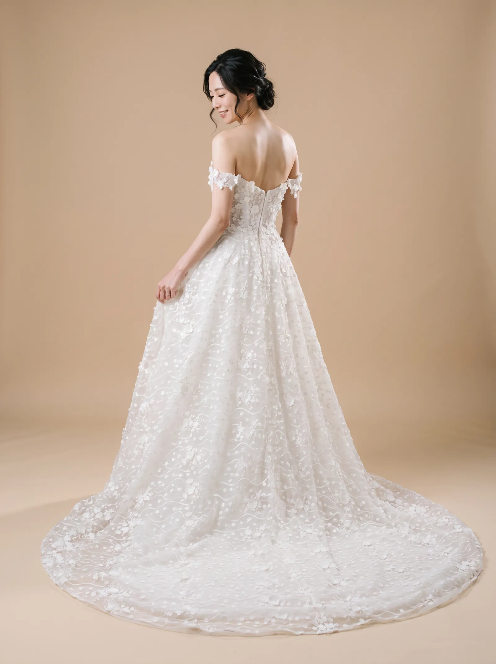 Magnolia wedding gown, back - over-shoulder gaze lowered