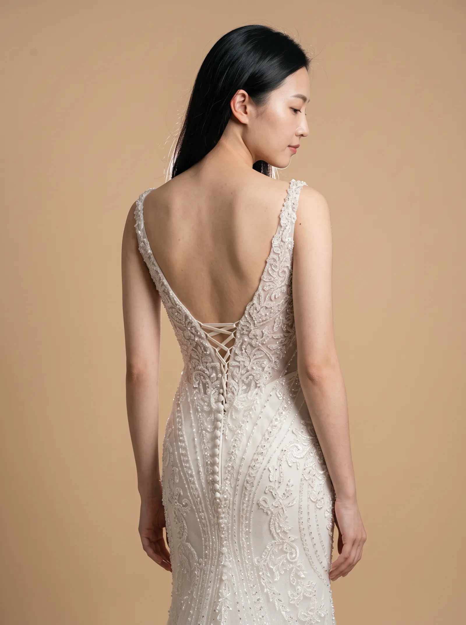 Selene wedding gown, three-quarter close - back, glancing over the shoulder