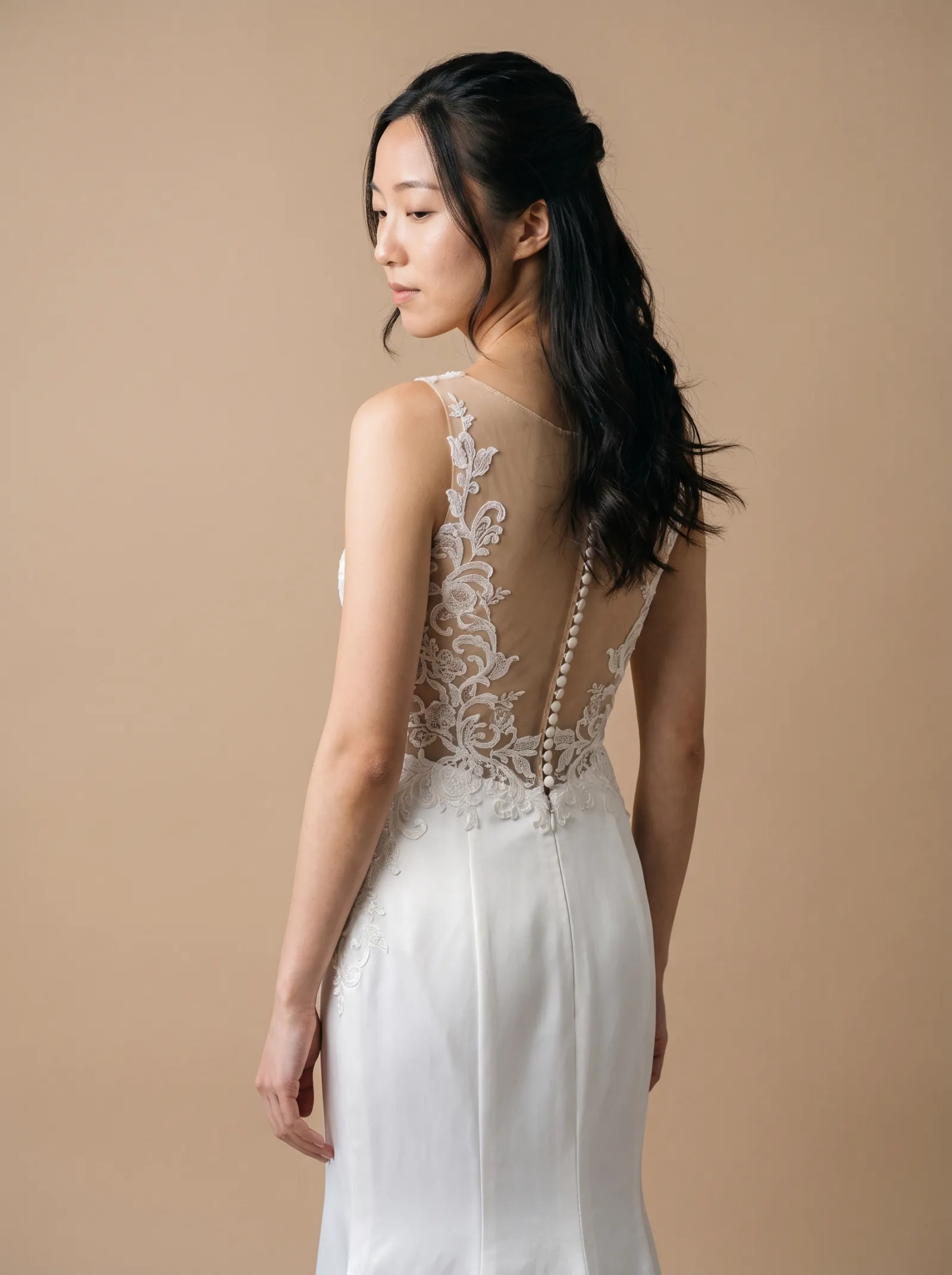 Eliana wedding gown, three-quarter close - back, glancing over the shoulder
