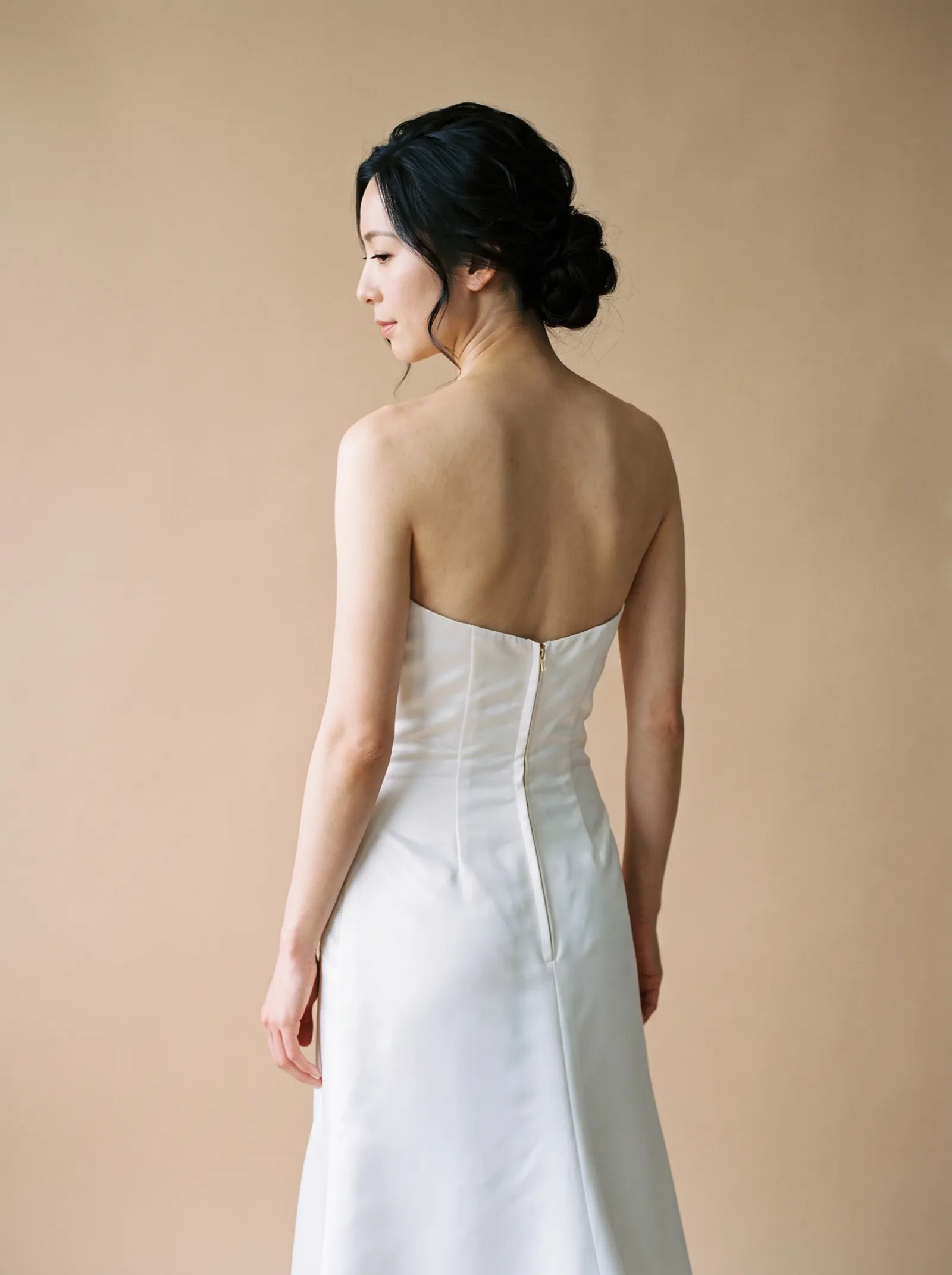 Sloane wedding gown, three-quarter close - back, glancing over the shoulder