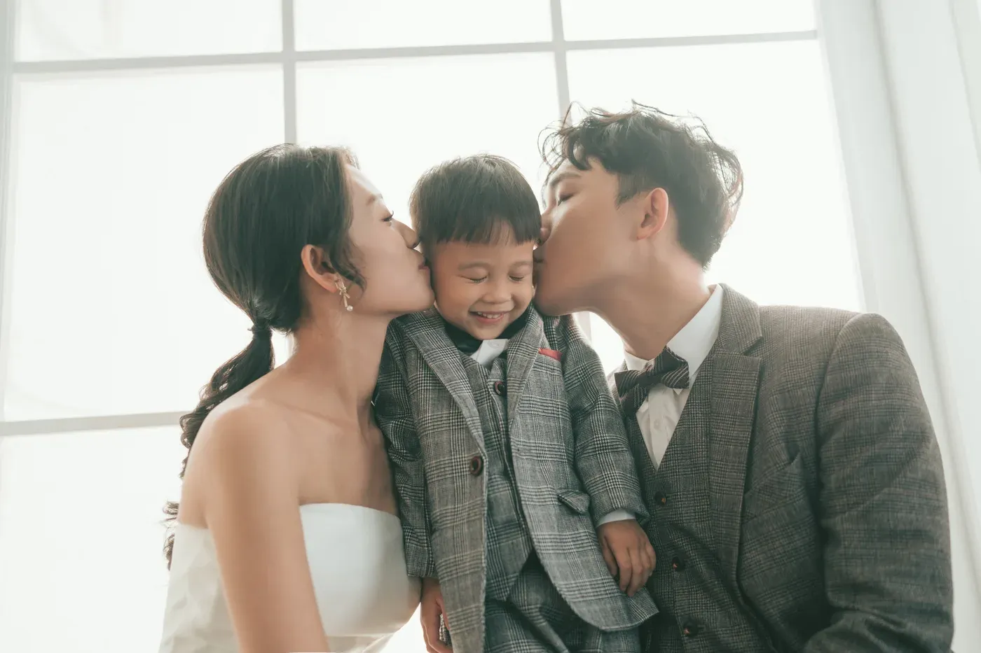 Formal family portrait in gowns and suits - family photo studio Singapore