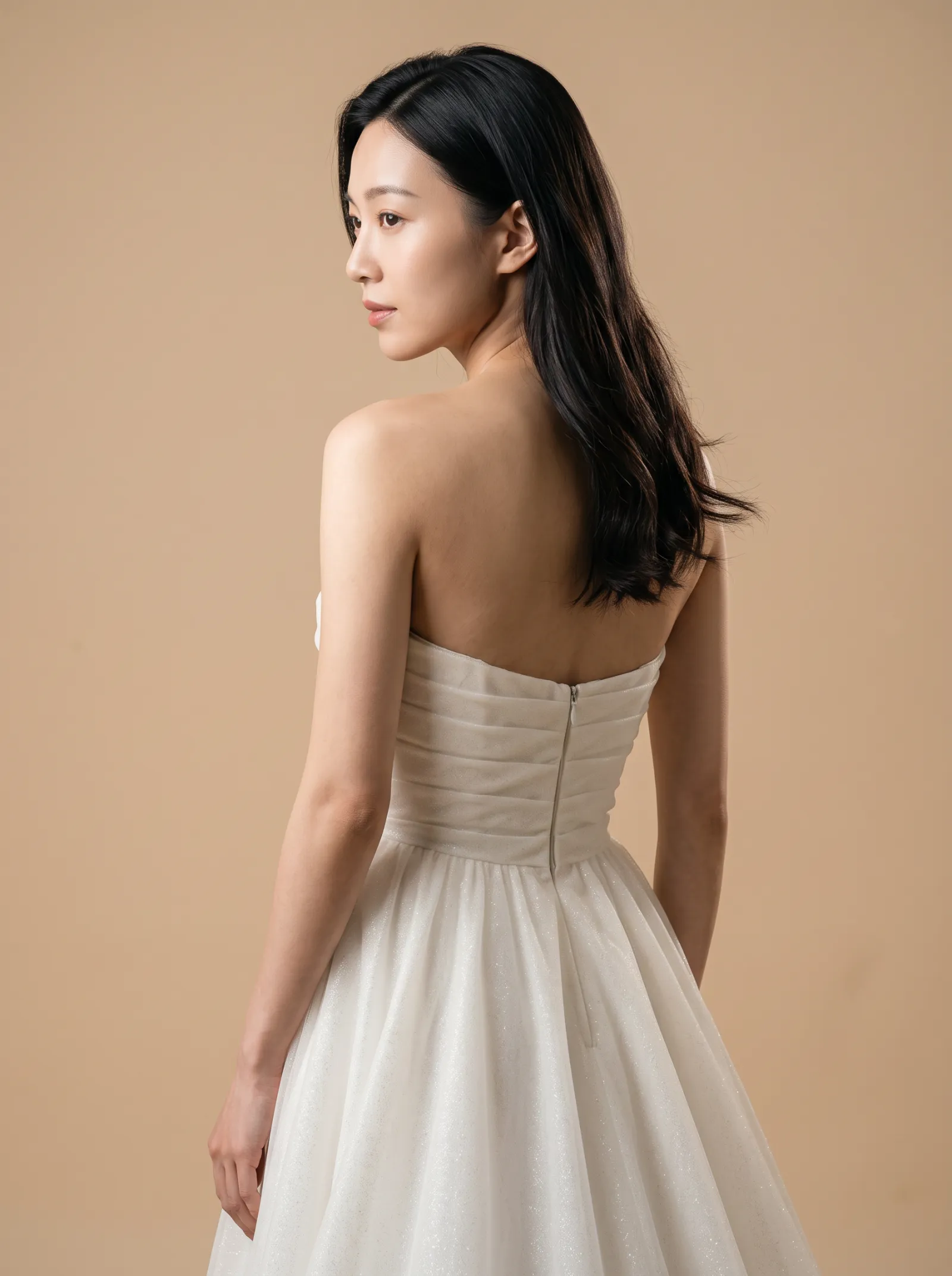 Elara wedding gown, three-quarter close - back, glancing over the shoulder