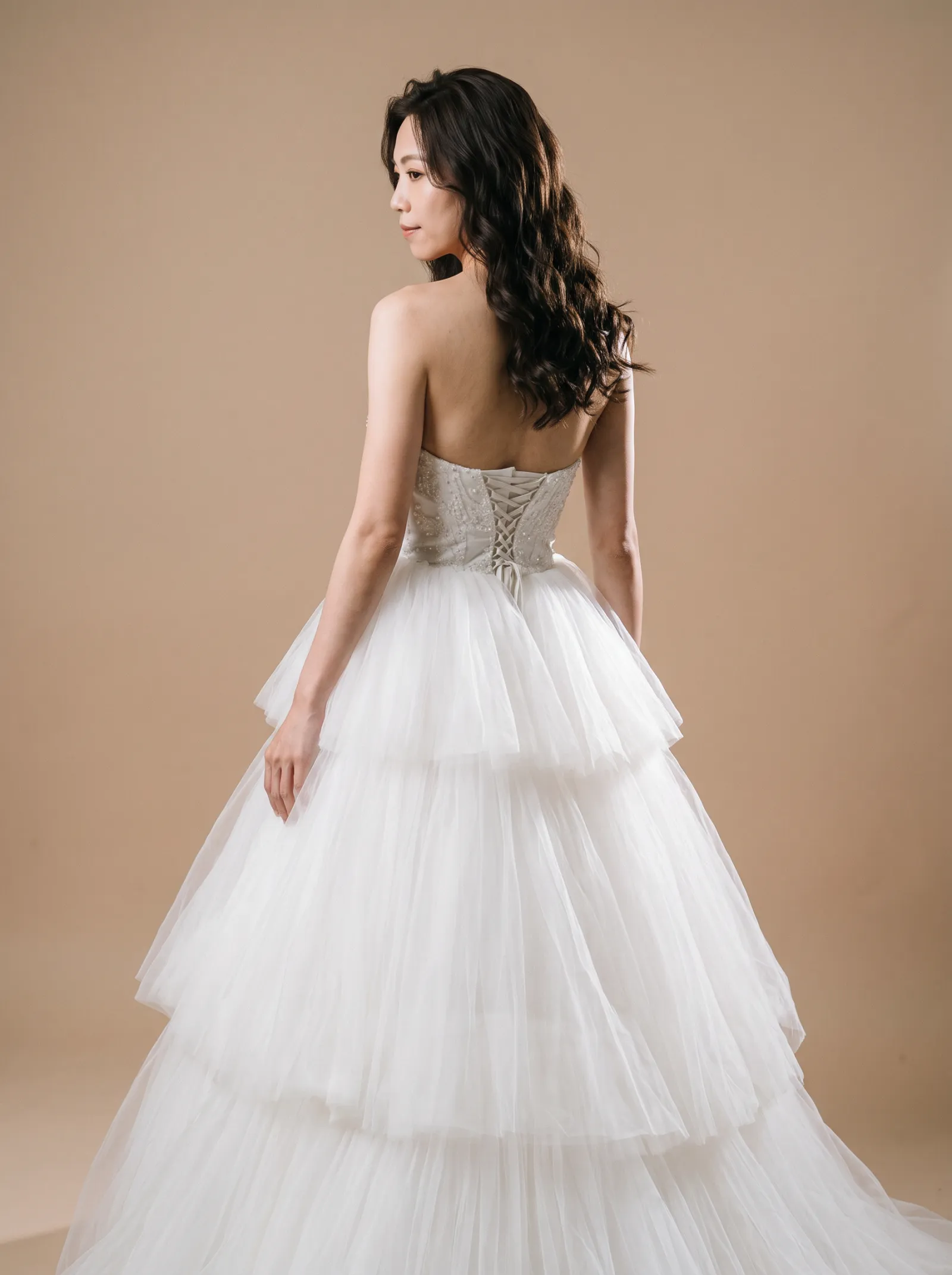 Odette wedding gown, three-quarter close - back, glancing over the shoulder