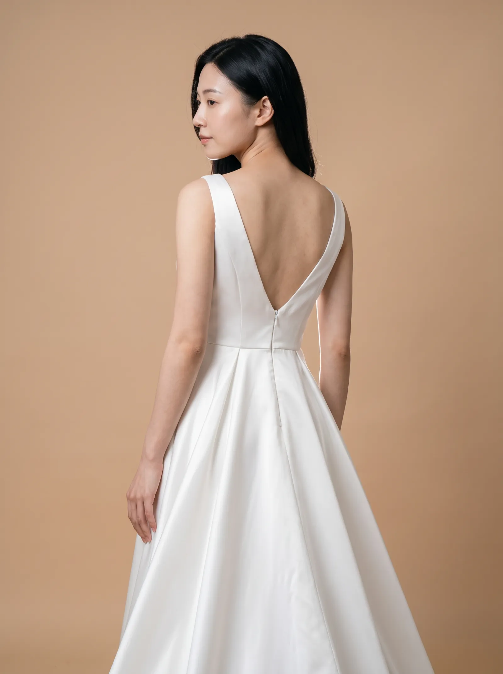 Bianca wedding gown, three-quarter close - back, glancing over the shoulder