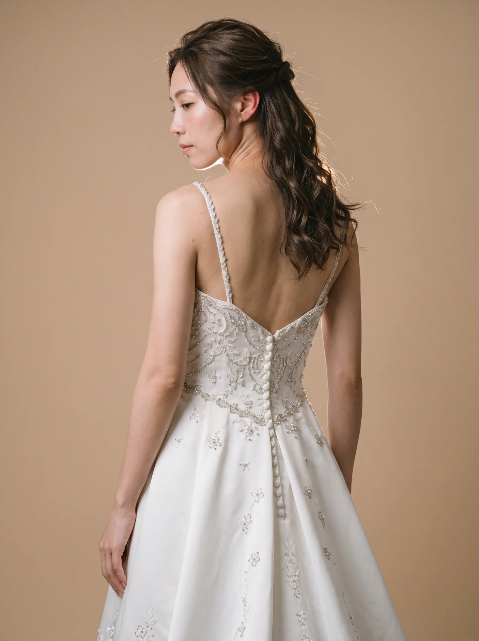 Cordelia wedding gown, three-quarter close - back, glancing over the shoulder