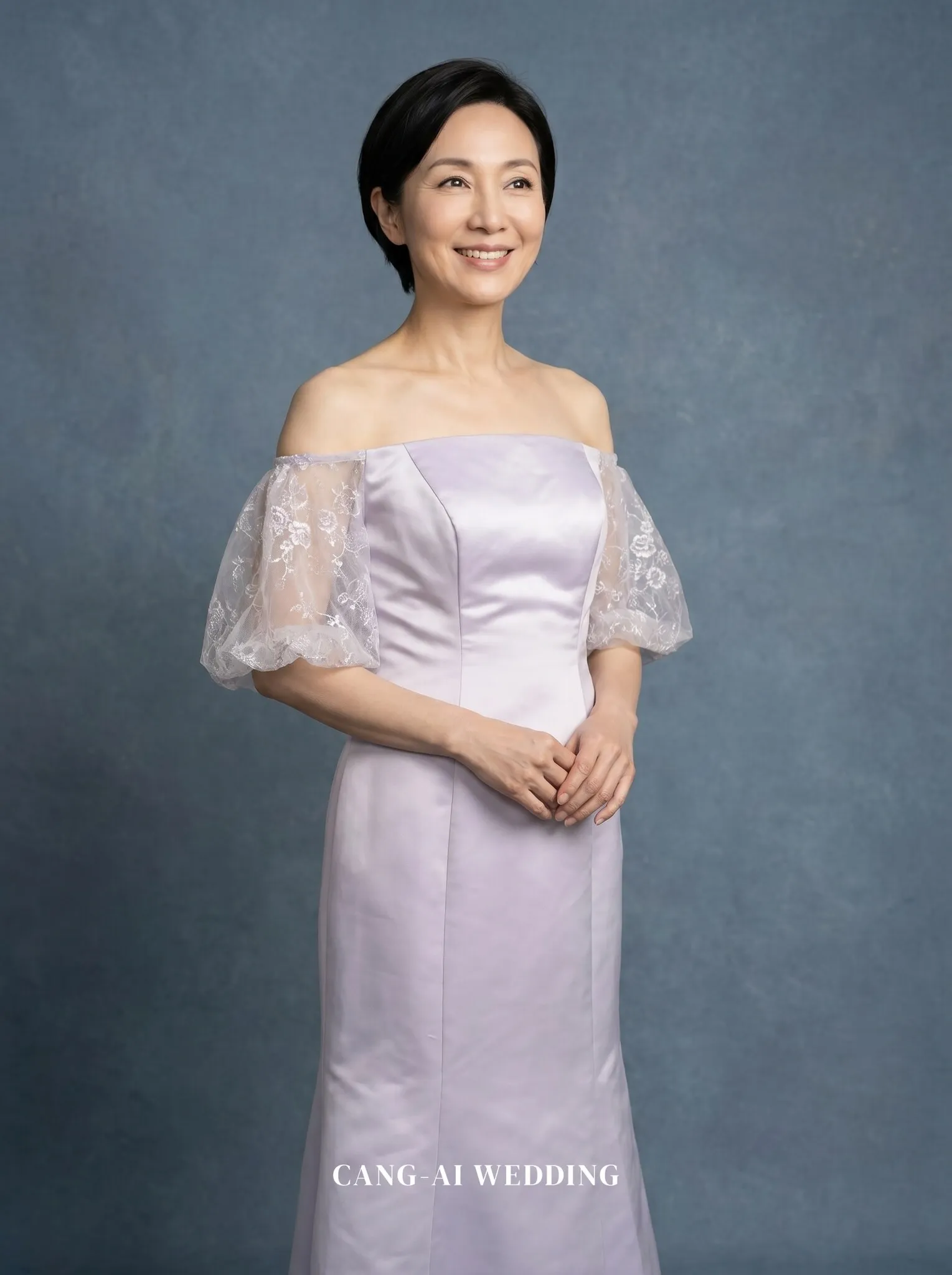 mother_gown_67 - Gently clasping hands at the waist