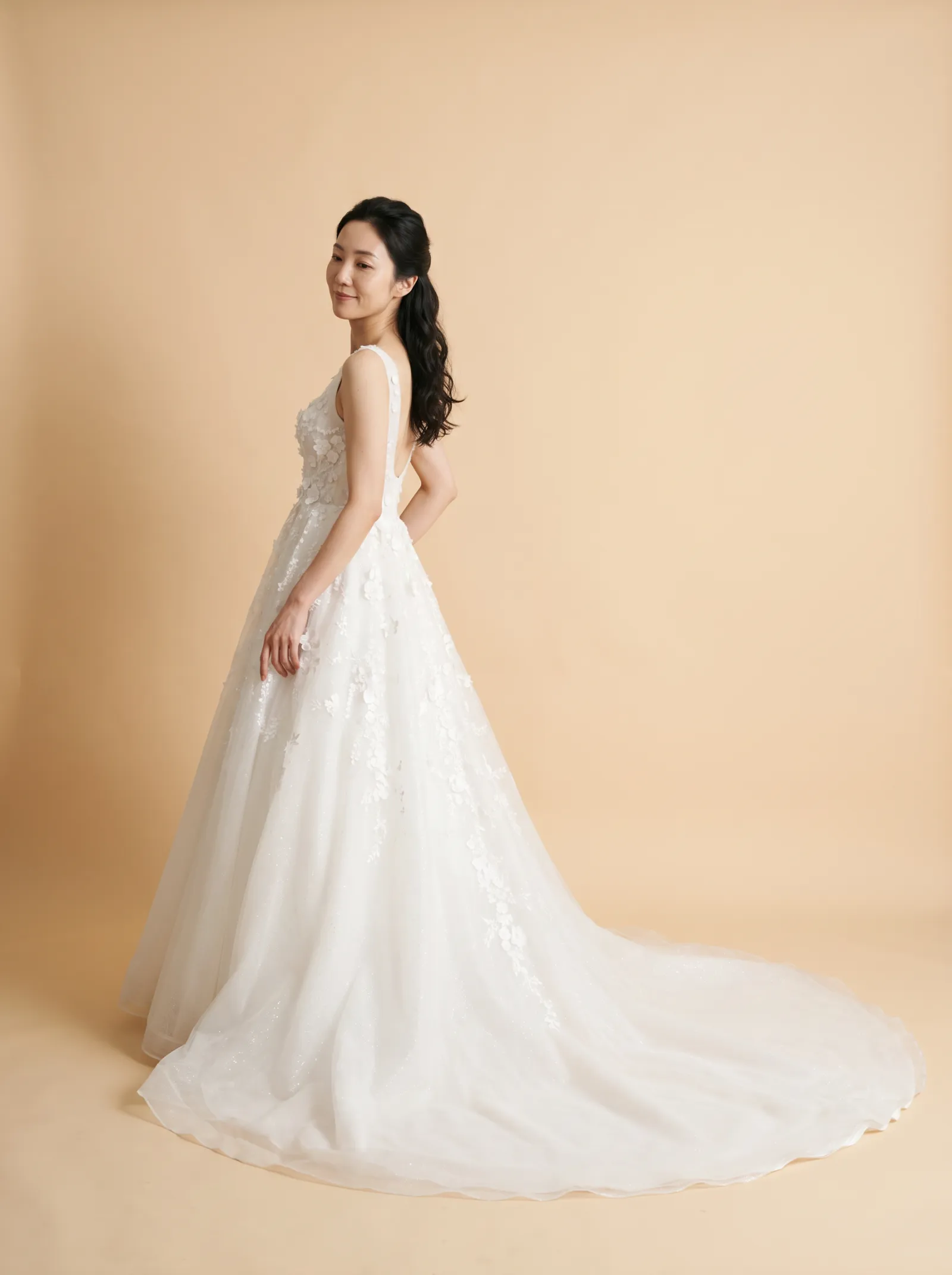 Thea wedding gown, back full-length with an over-shoulder glance