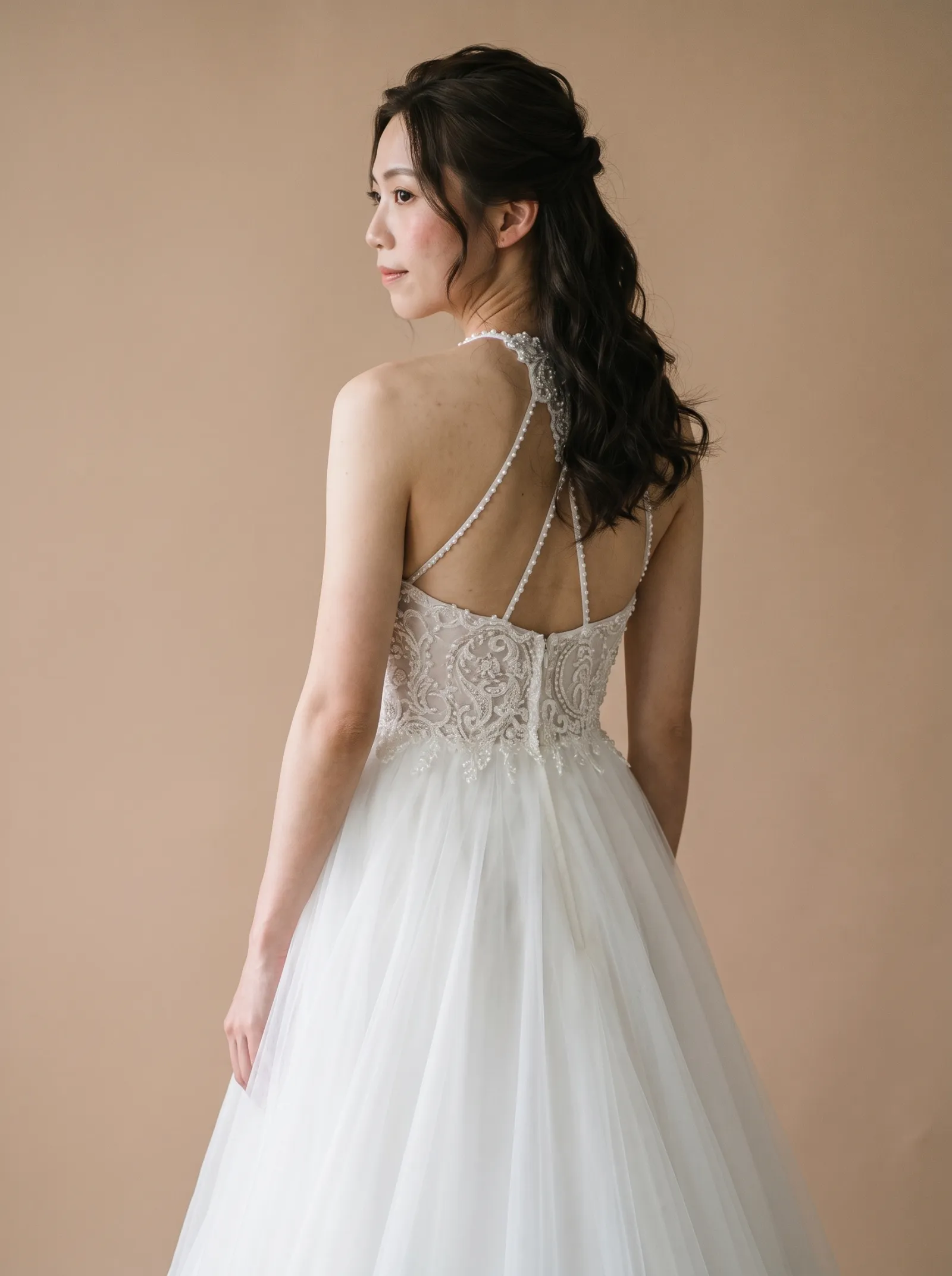 Lyra wedding gown, three-quarter close - back, glancing over the shoulder